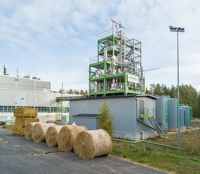 image of a bioprocess facility with straw bales in front